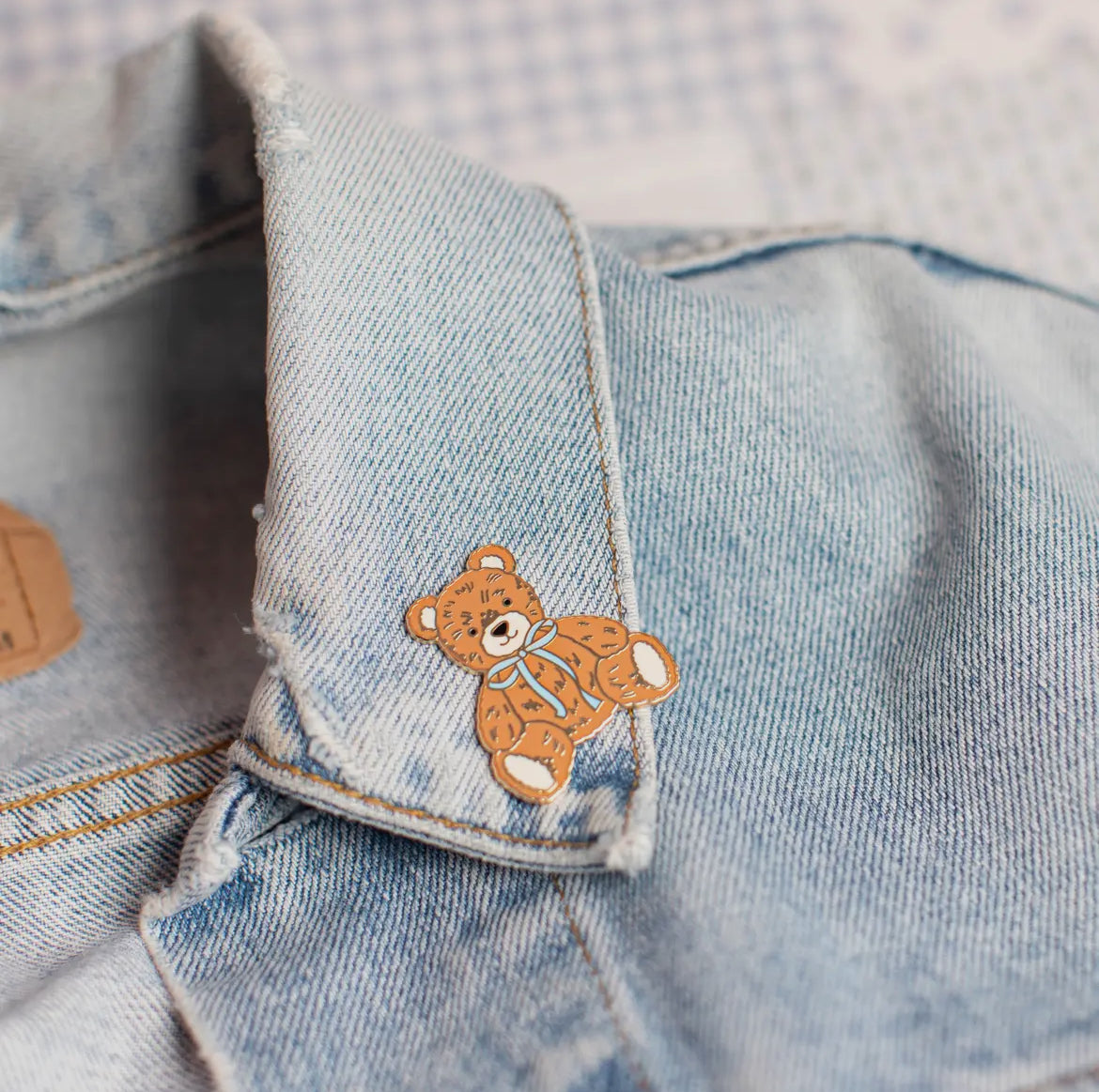 Teddy bear with blue bow pin