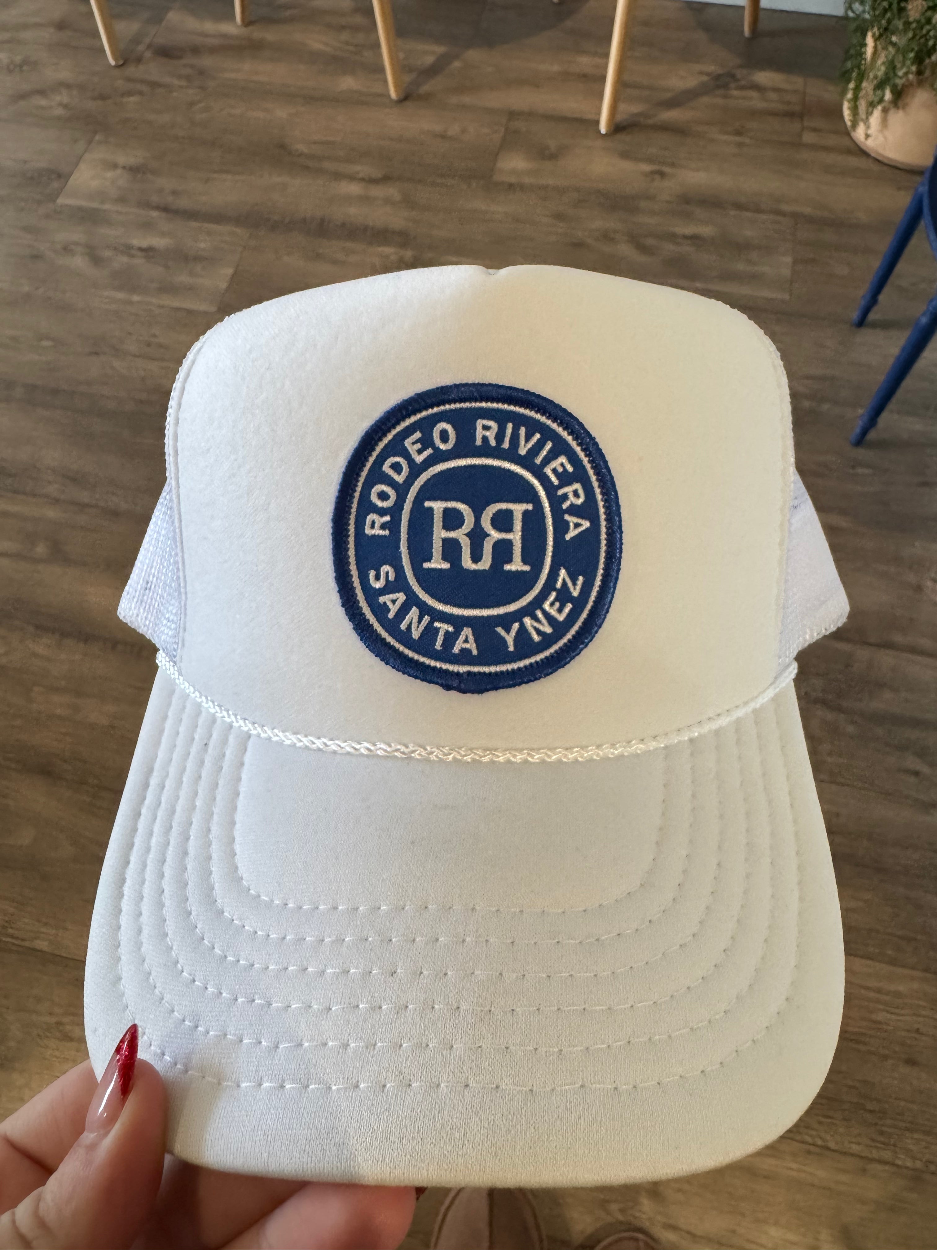 White foam trucker hat with rodeo riviera patch