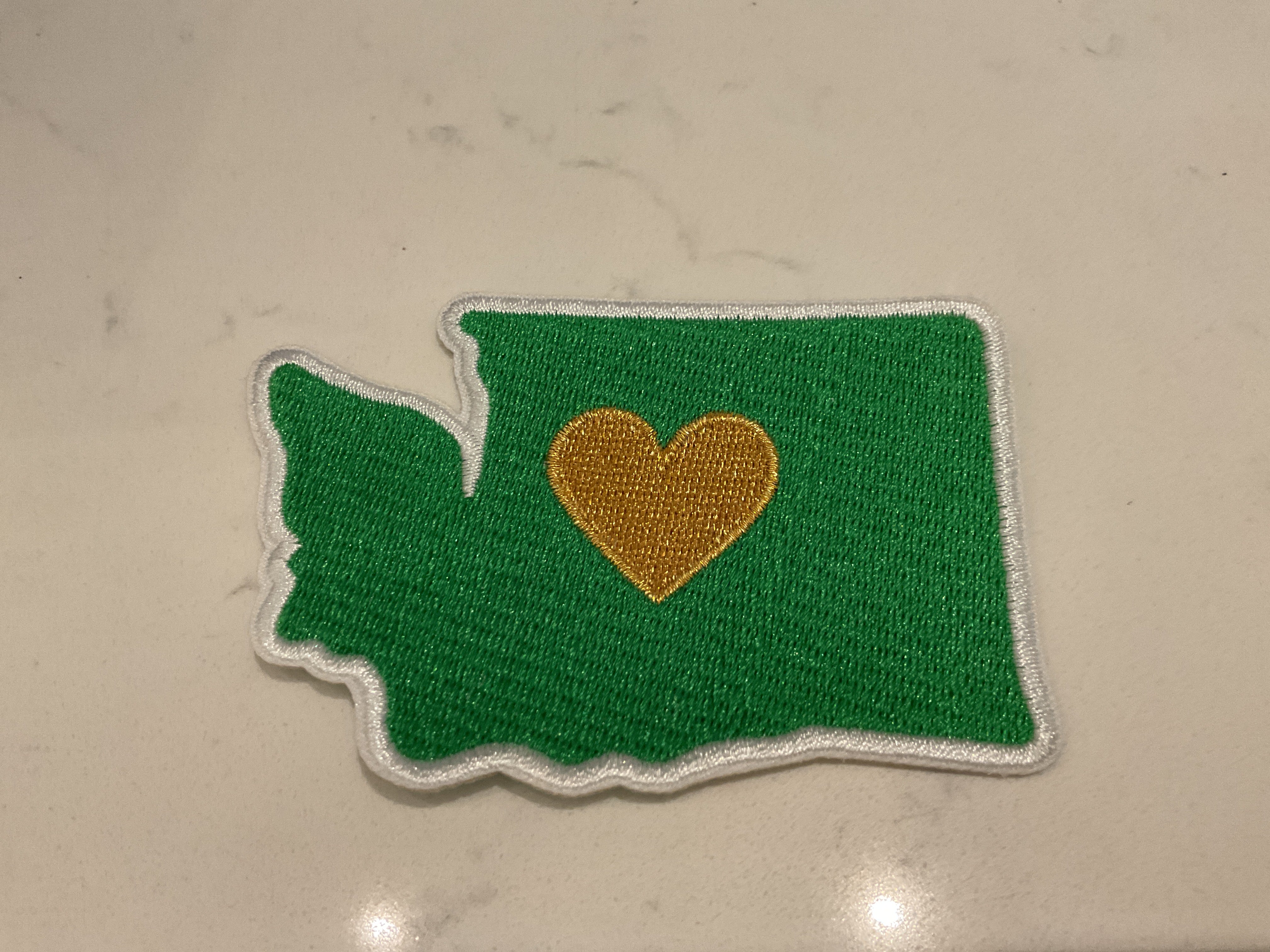 Gold heart in the middle of the state Washington patch