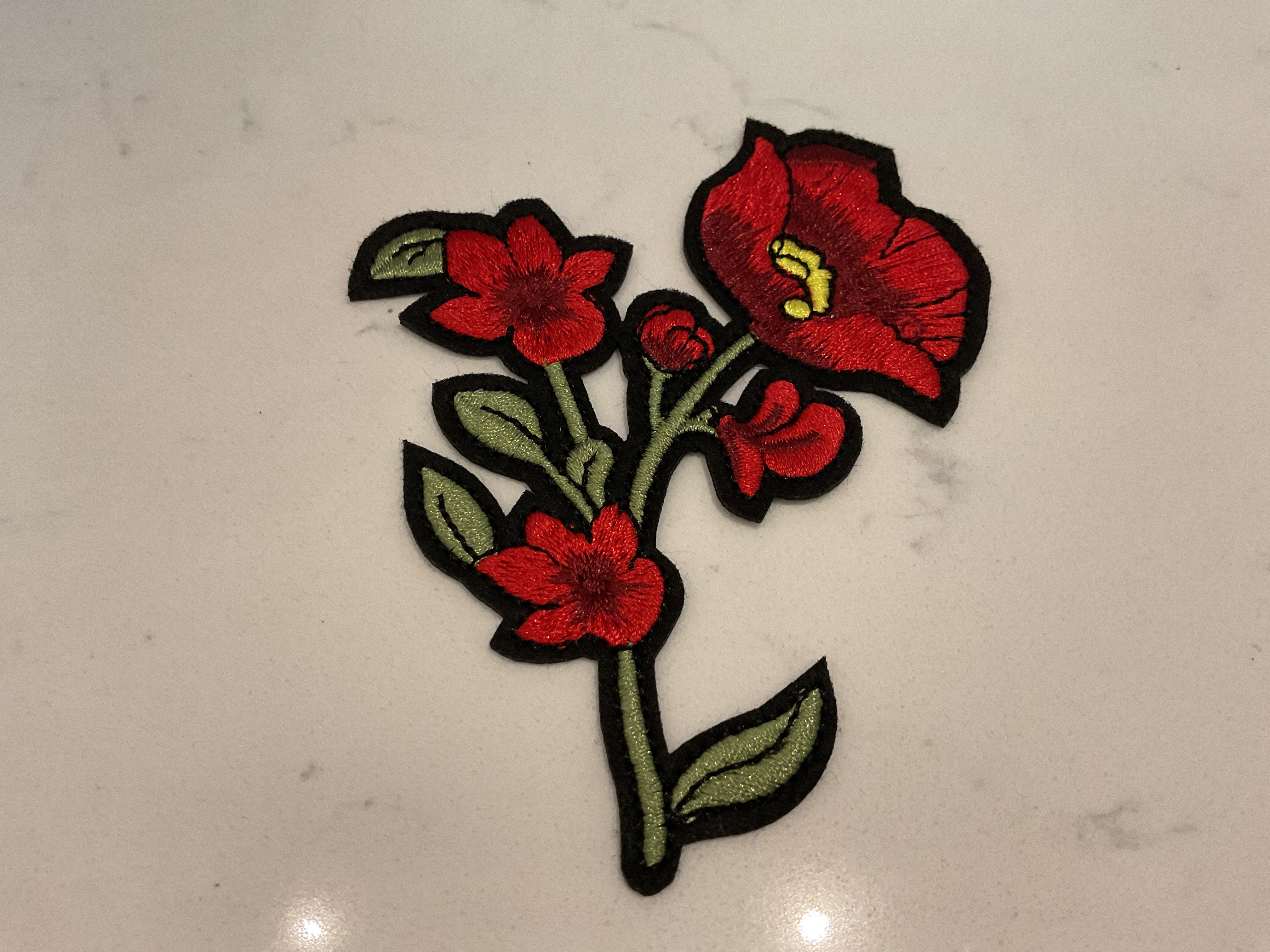 Red flower with vine patch