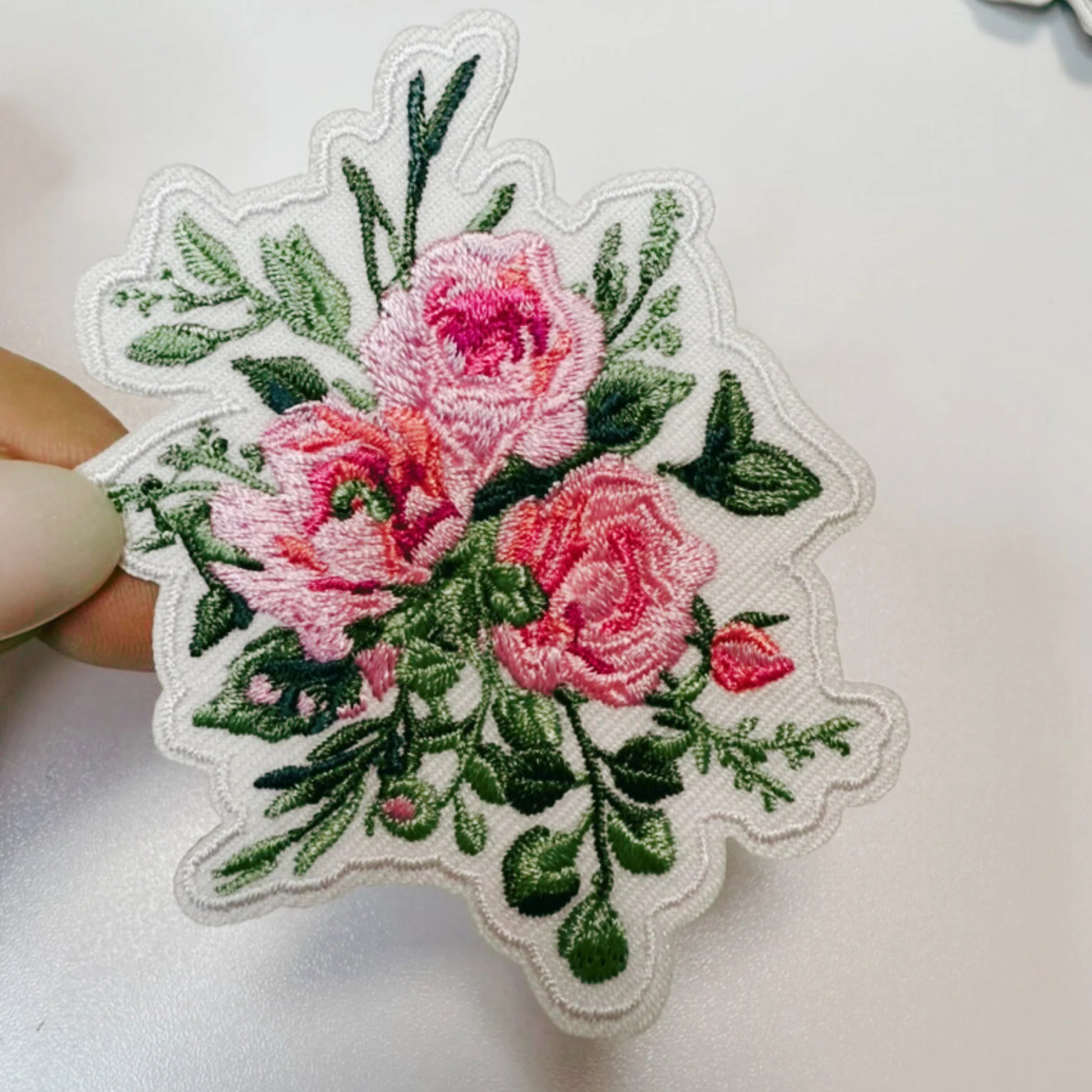 Pink roses with green leaves patch