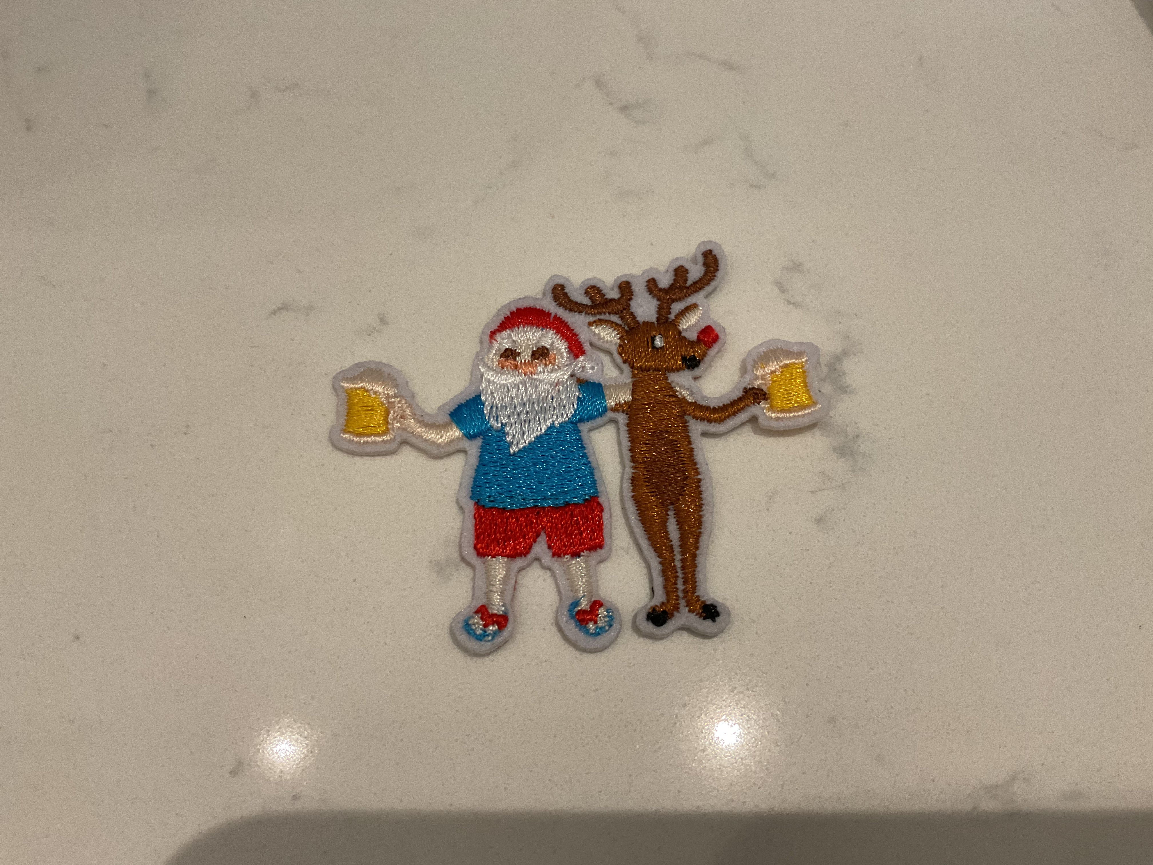 Santa and a reindeer holding beer patch