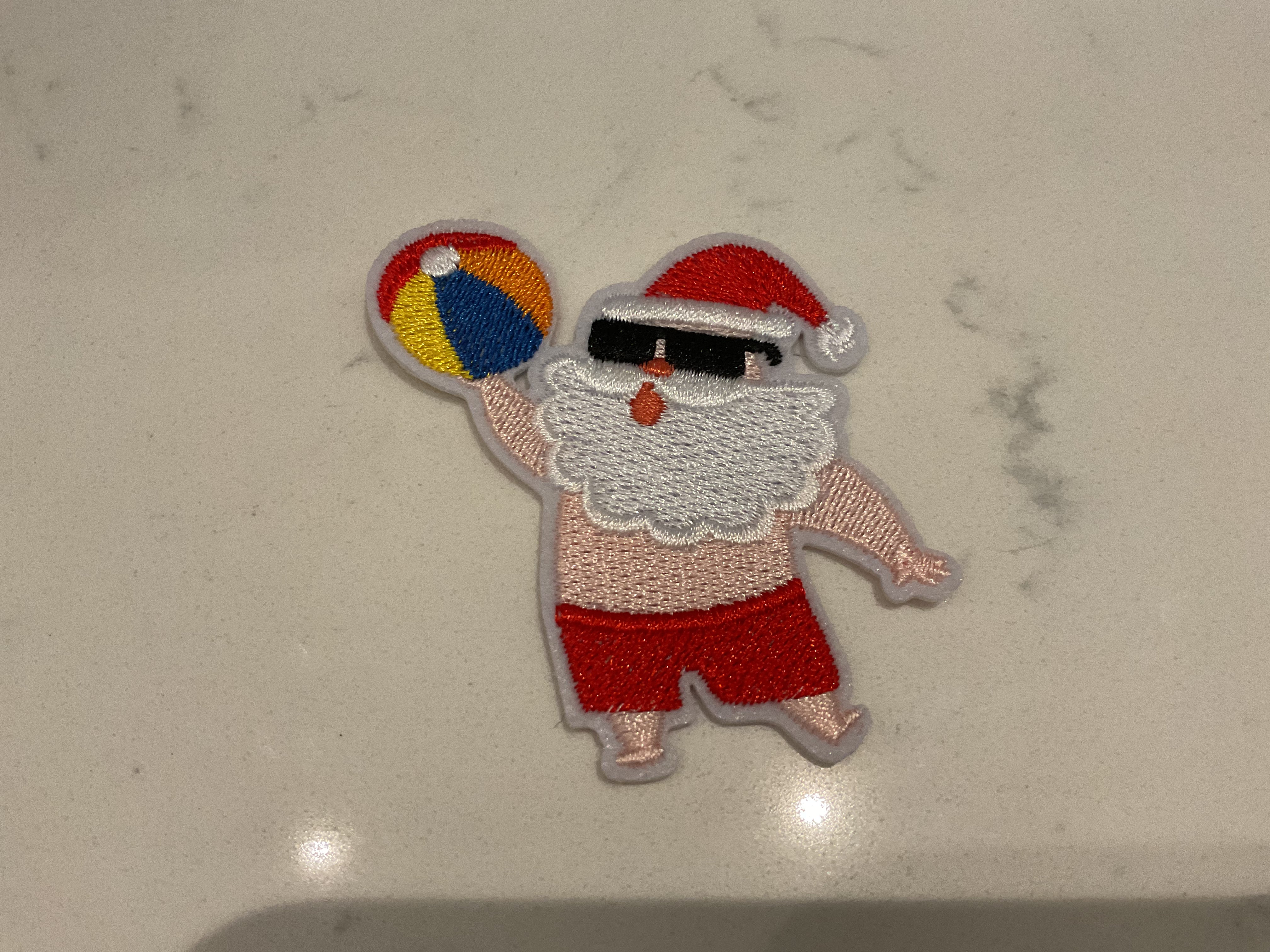 Santa holding a beach ball patch