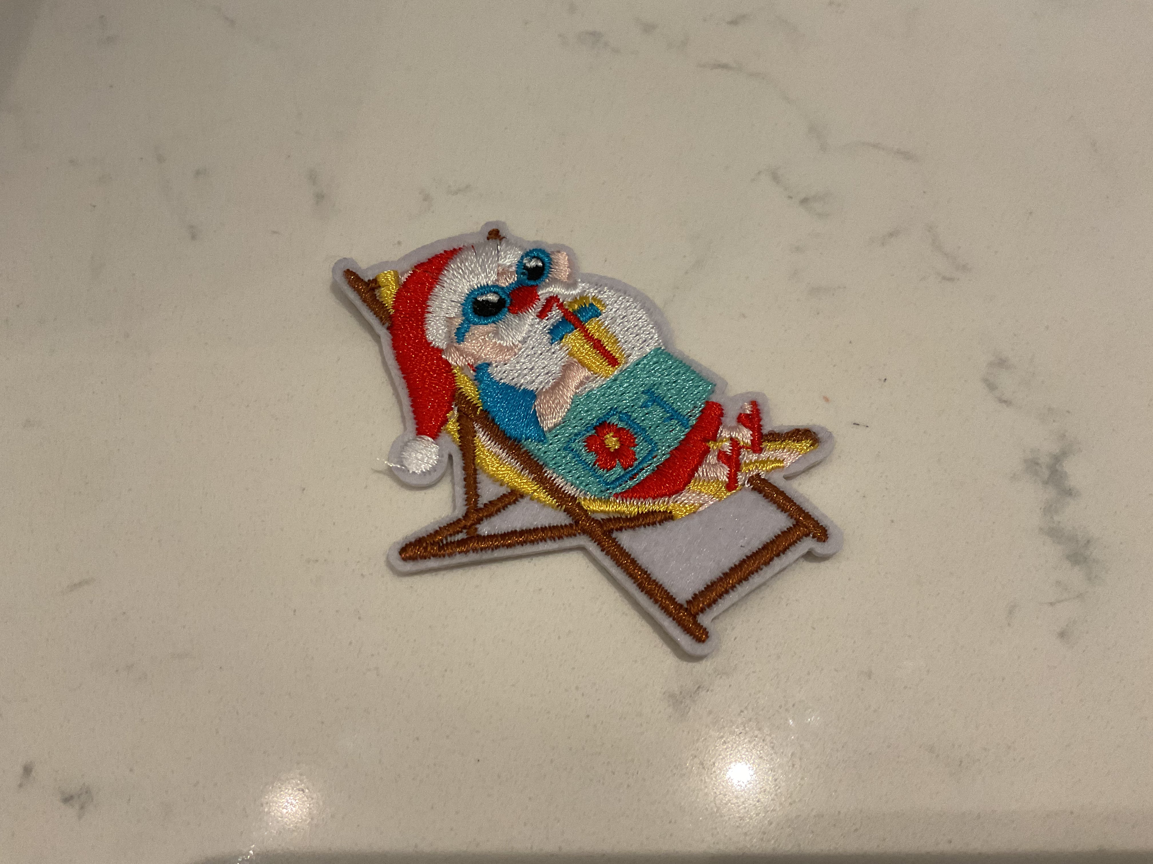 Santa sitting in a beach chair sipping a drink patch