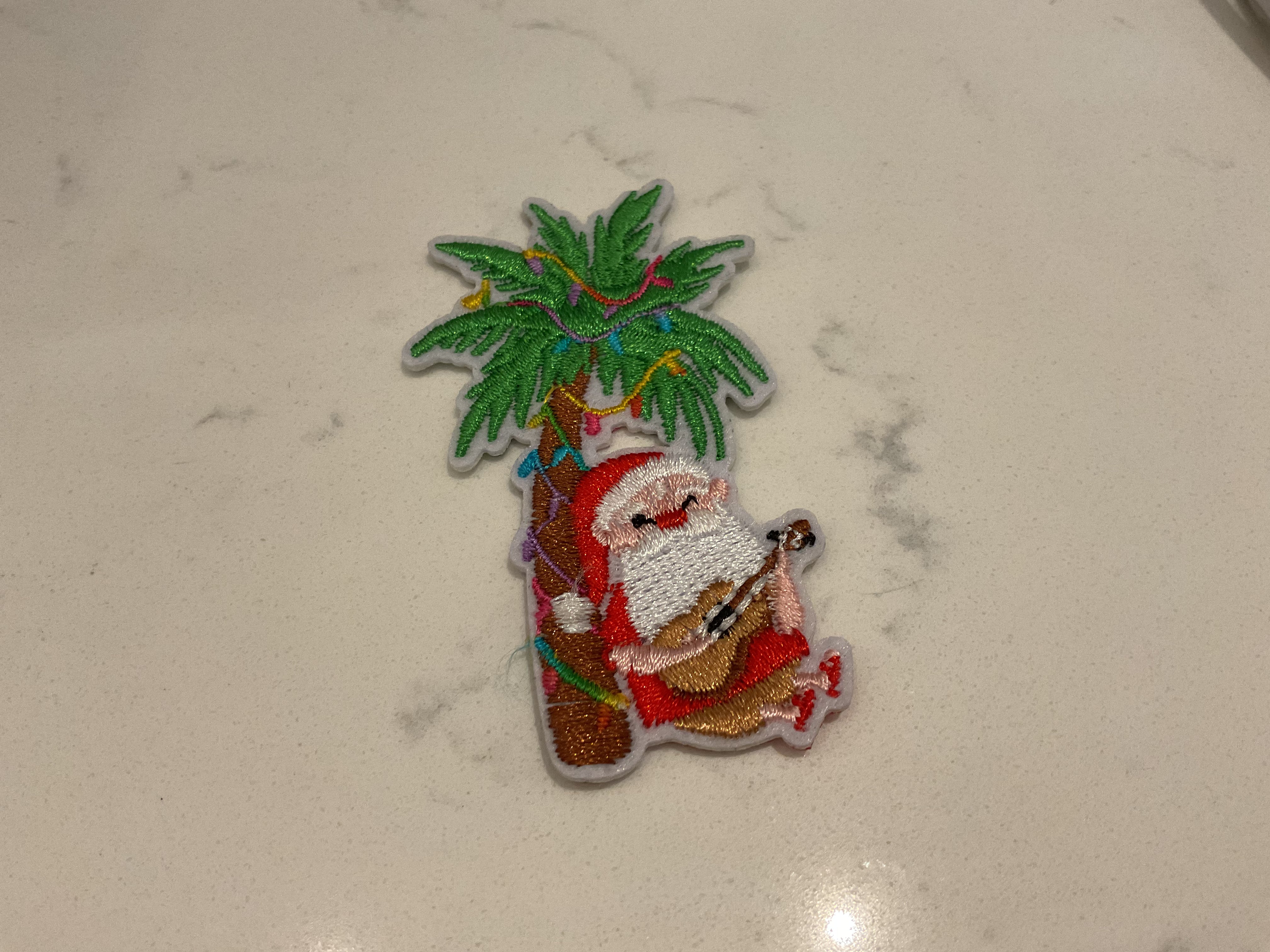 Santa playing guitar under a palm tree patch