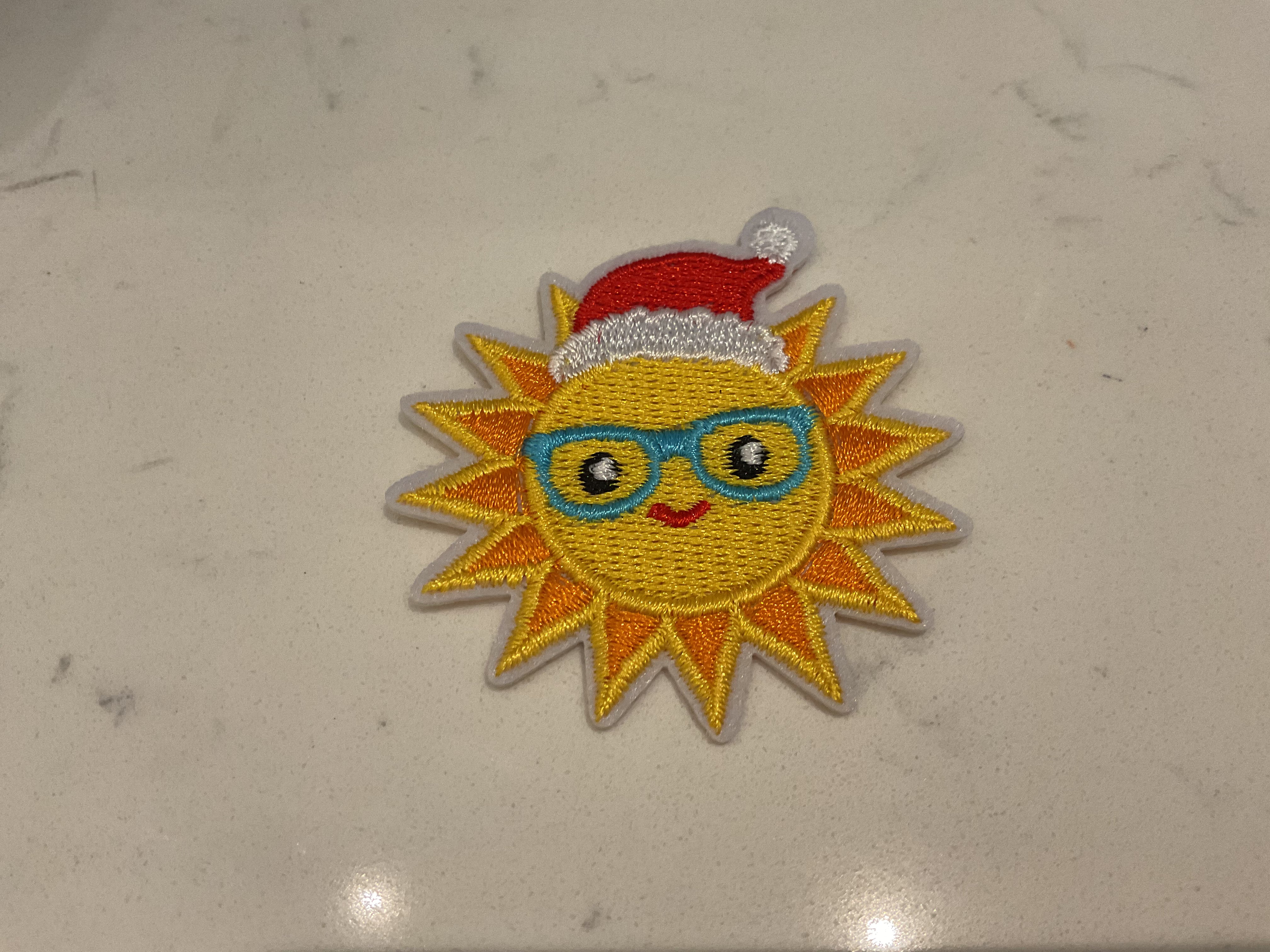 Sun with a Santa hat patch