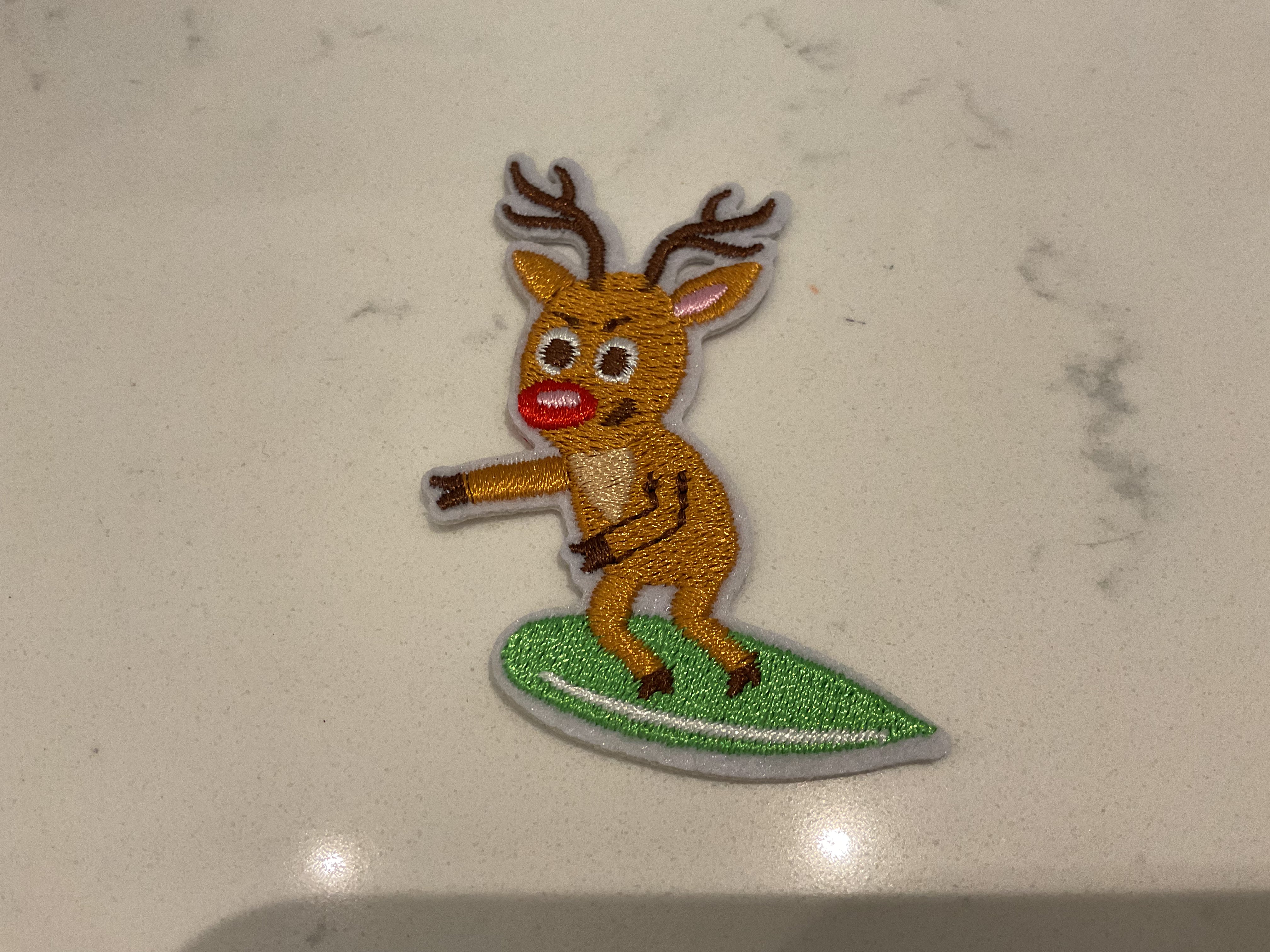 Reindeer riding a surfboard patch