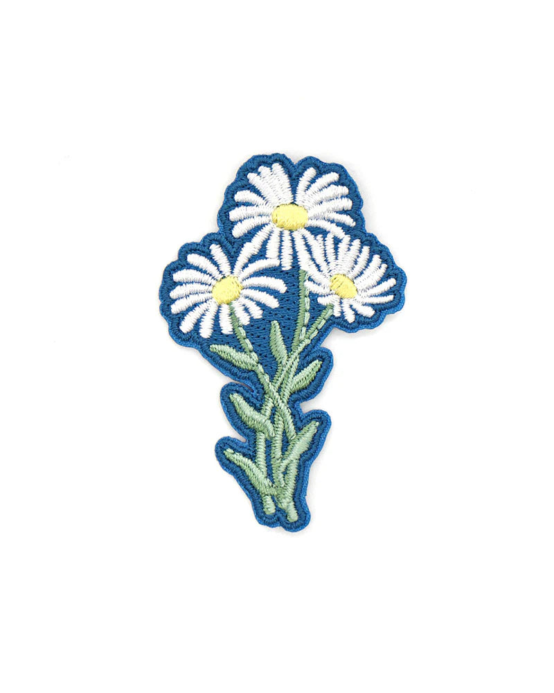 White flower with blue background patch